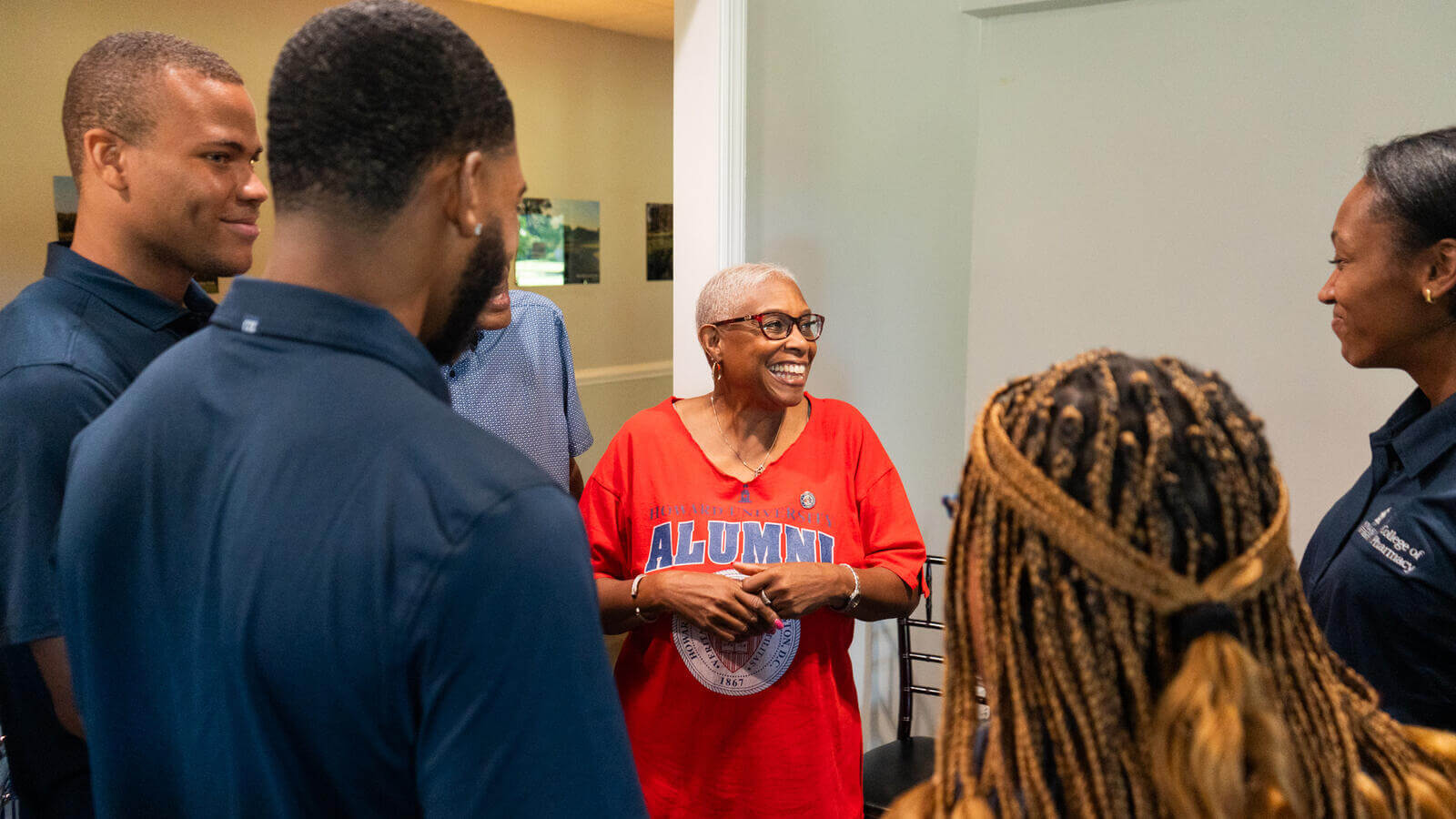 woman surrounded by students in conversation
